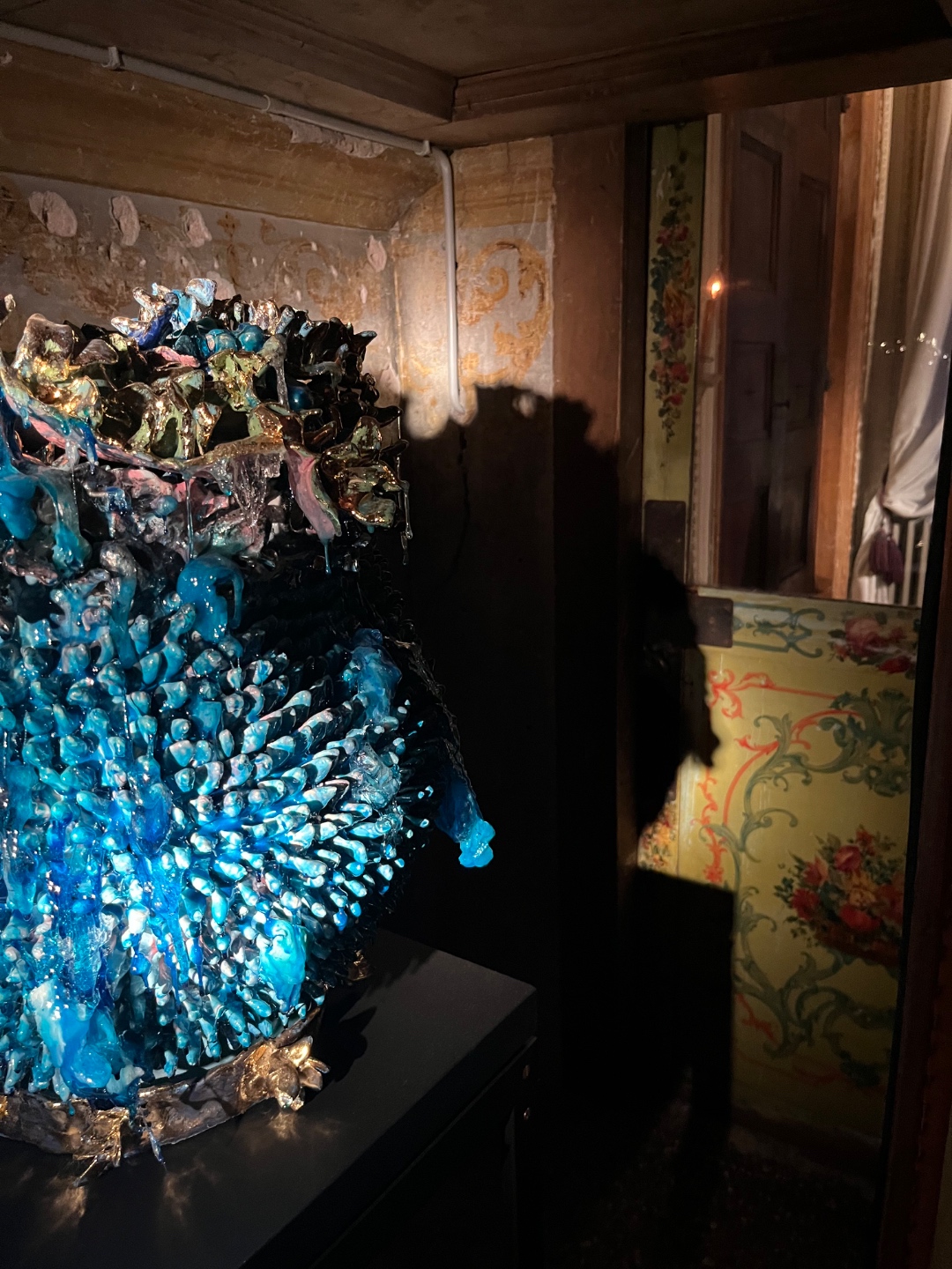 Luminous blue Venetian glass sculpture beside frescoed and mirrored walls — Venice Biennale 2026